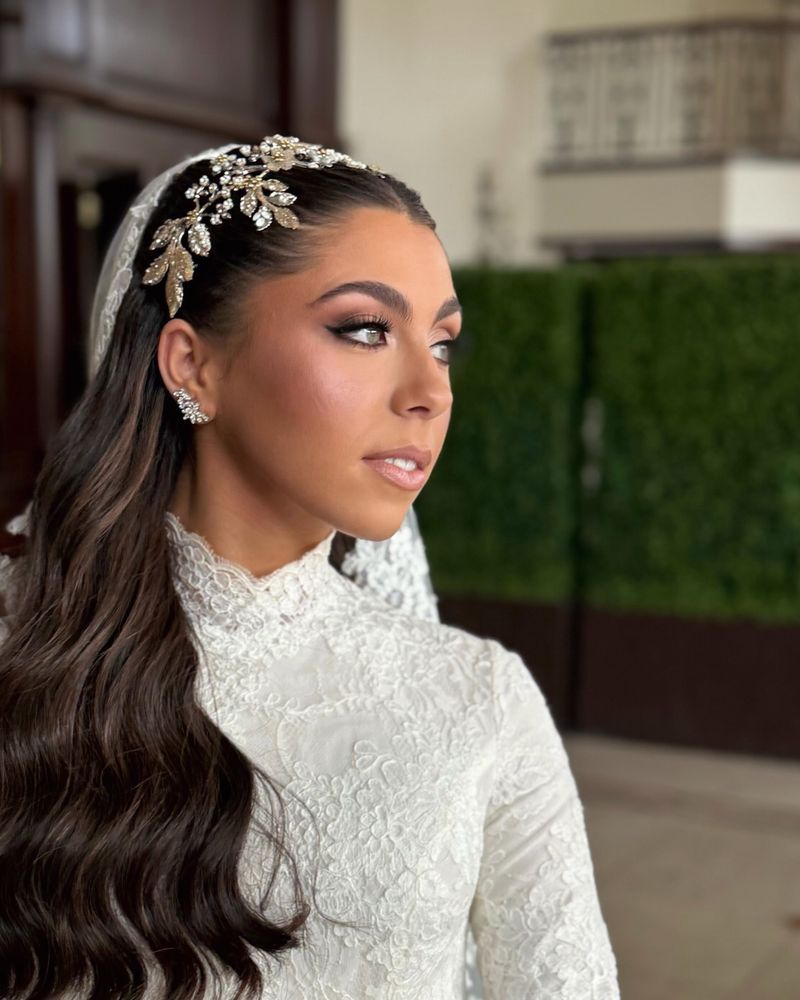Bride in profile with a jeweled headpiece and long waves